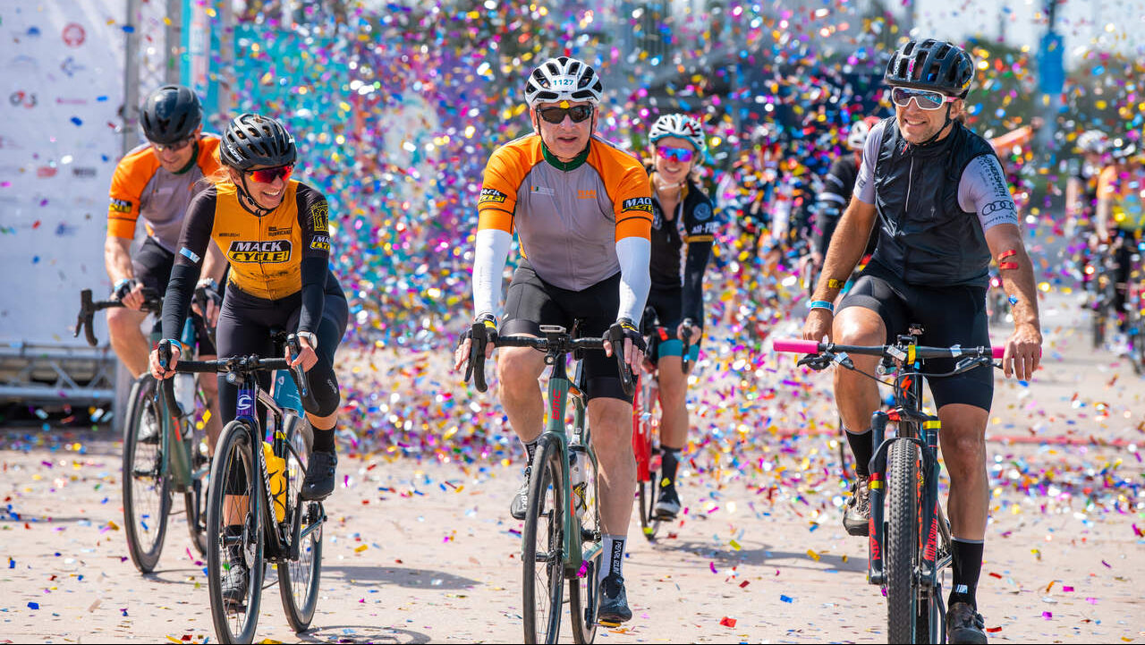Dr. Stephen Nimer crossing the dcc finish line with Rachel Losada, Randy Egues, and Vaughn Edelson.
