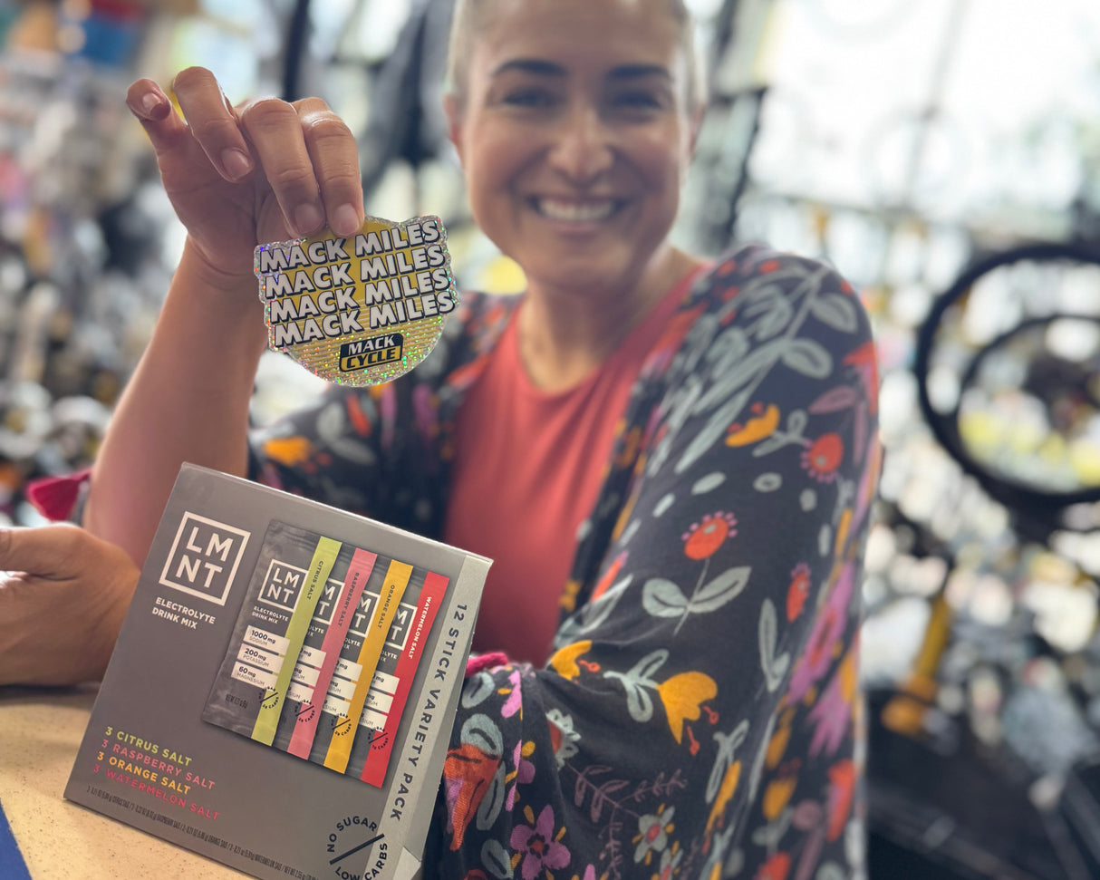 VALERIA RODRIGUEZ PICKING UP  HER MACK MILES STICKER AT MACK CYCLE AS WELL AS HER FREE LMNT 12 STICK VARIETY PACK.