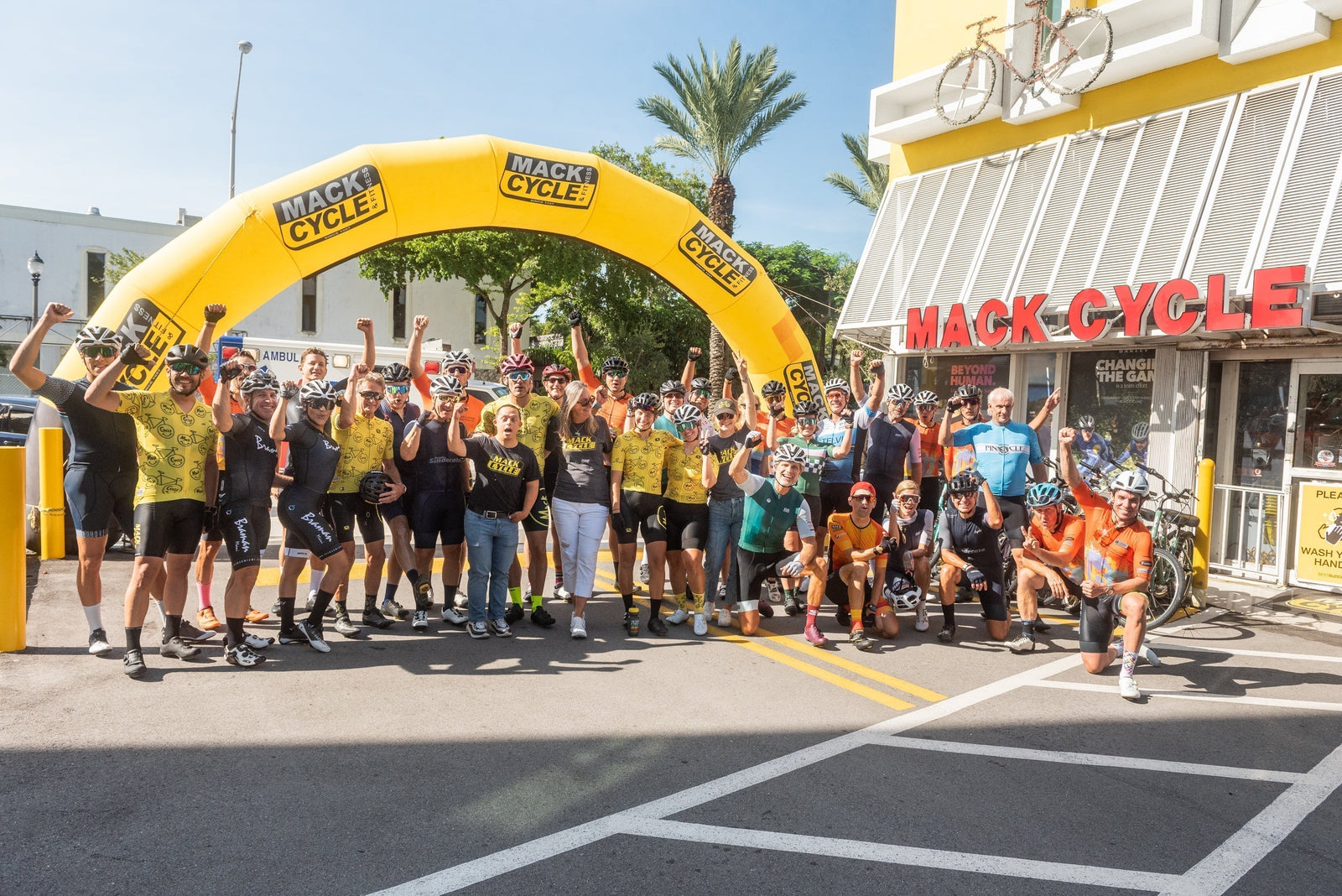 cyclists  at the best buddies challenge miami standing in front of miami's best bike shop, mack cycle 