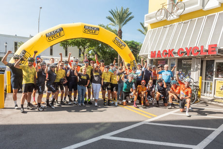 cyclists  at the best buddies challenge miami standing in front of miami's best bike shop, mack cycle 